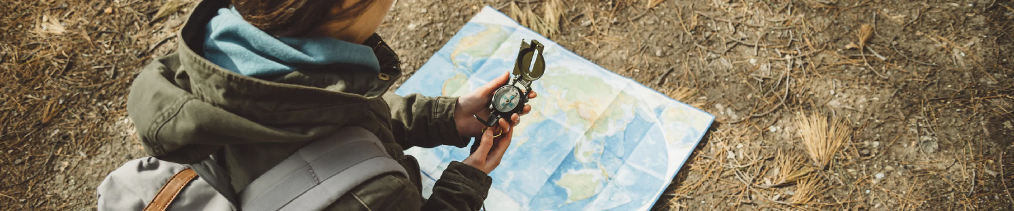 woman with map and compass travelling