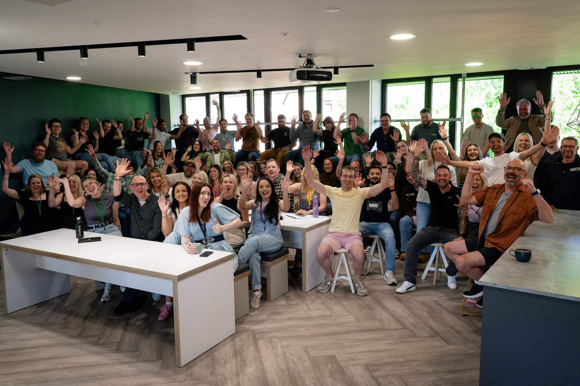 The Crafted team waving in the office.
