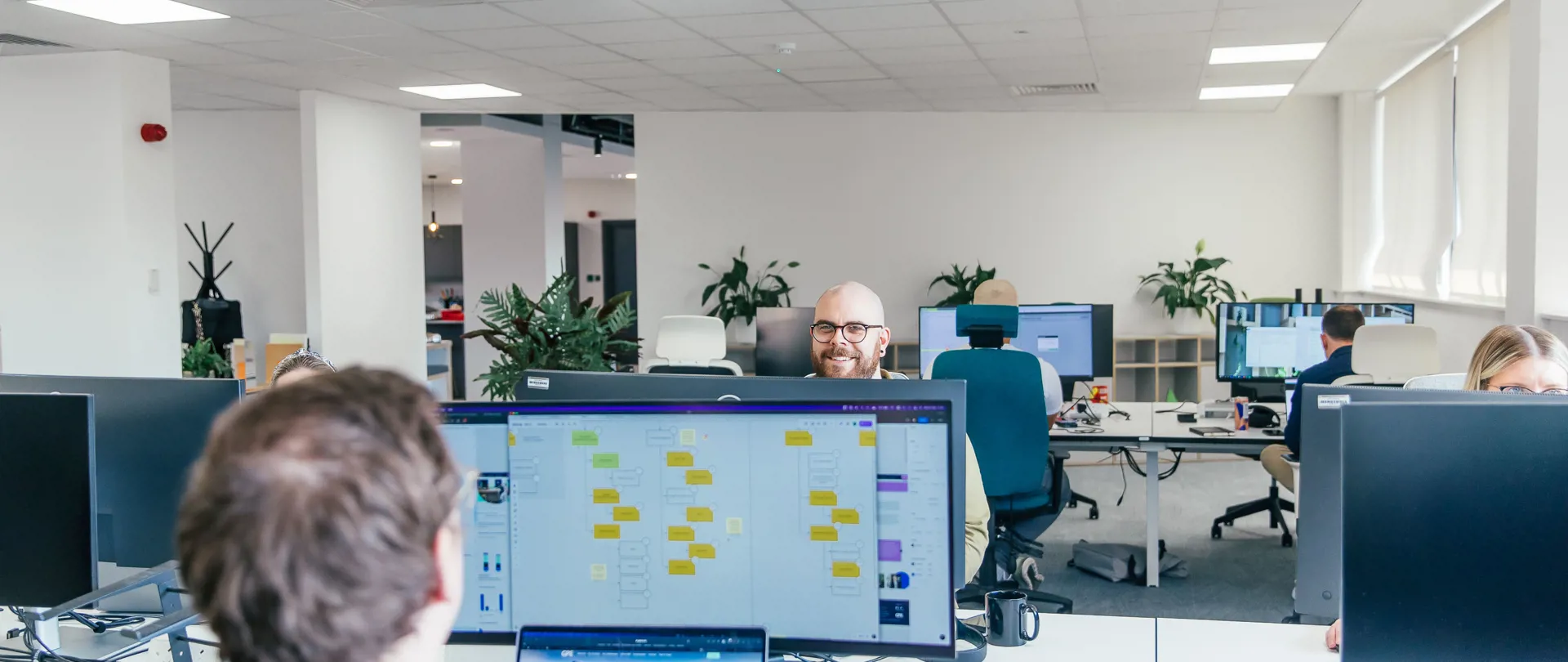 Crafted team members laughing to each other across the desk