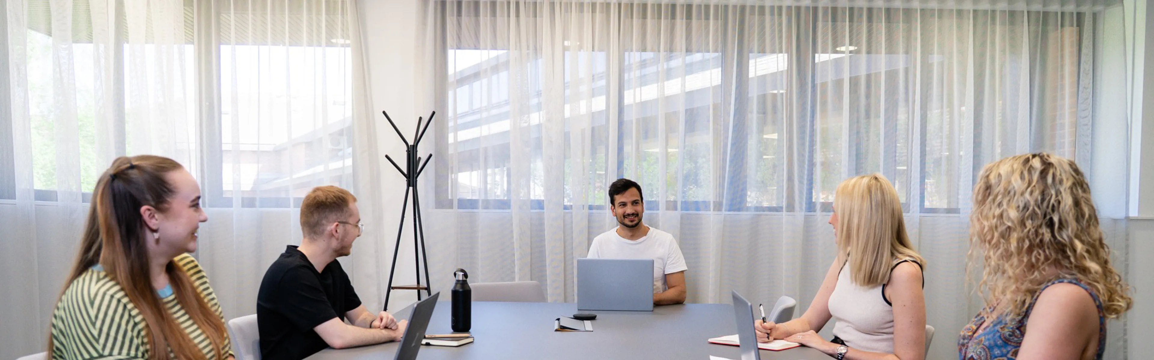 A Crafted team working around a desk in the office.