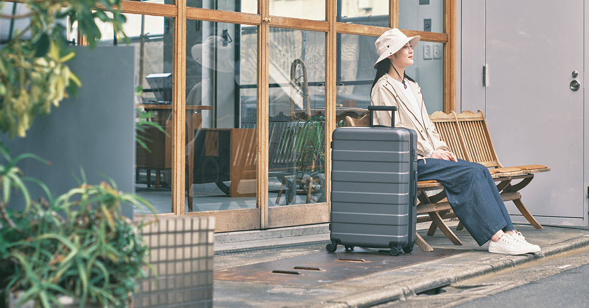 MUJI brand image lady with suitcase